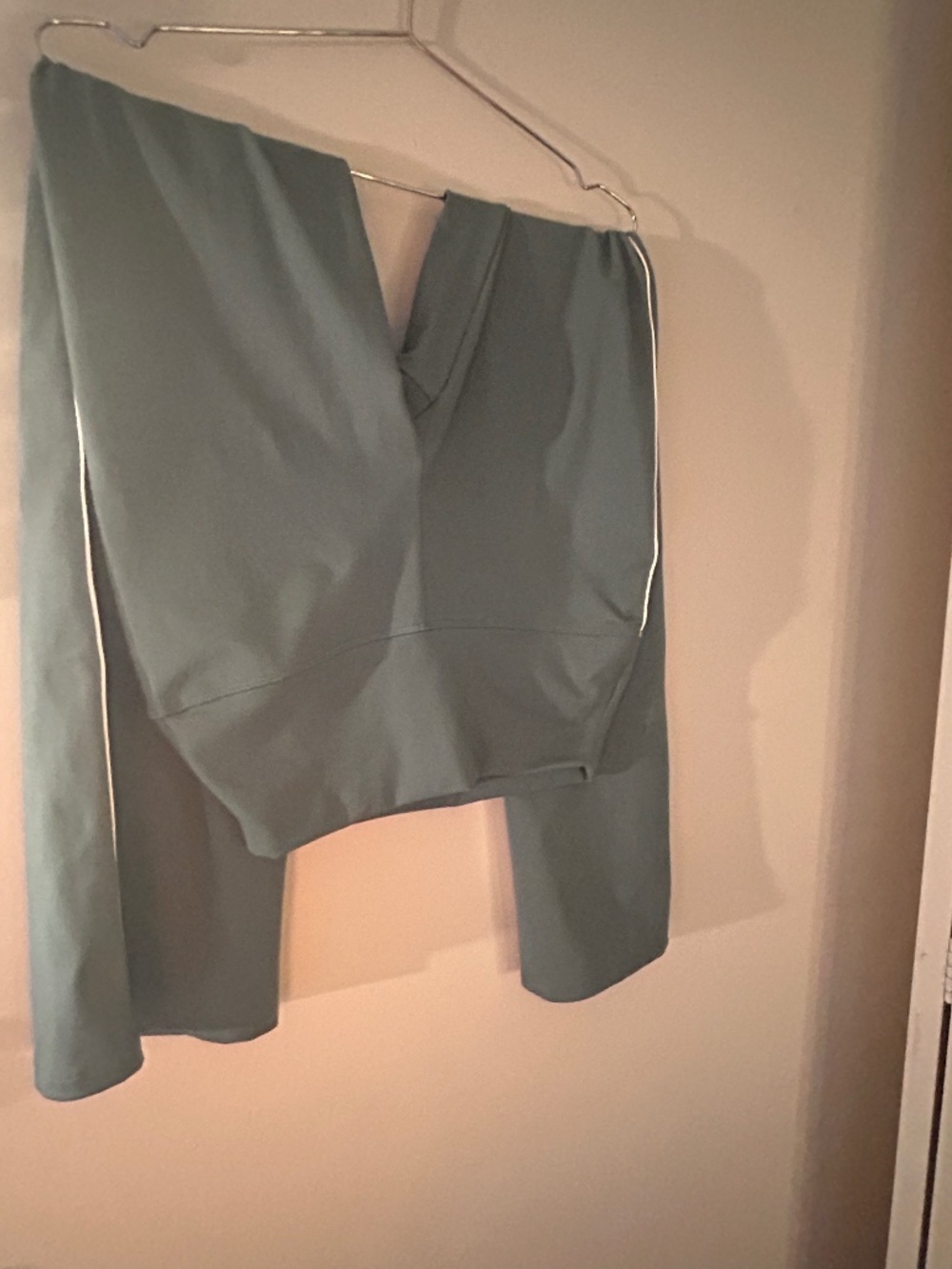 Green athletic pants with white stripe